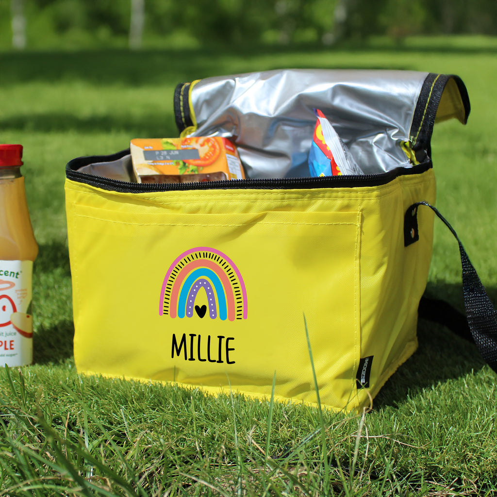 Yellow cooler bag with a rainbow design and 'Millie' text on grass