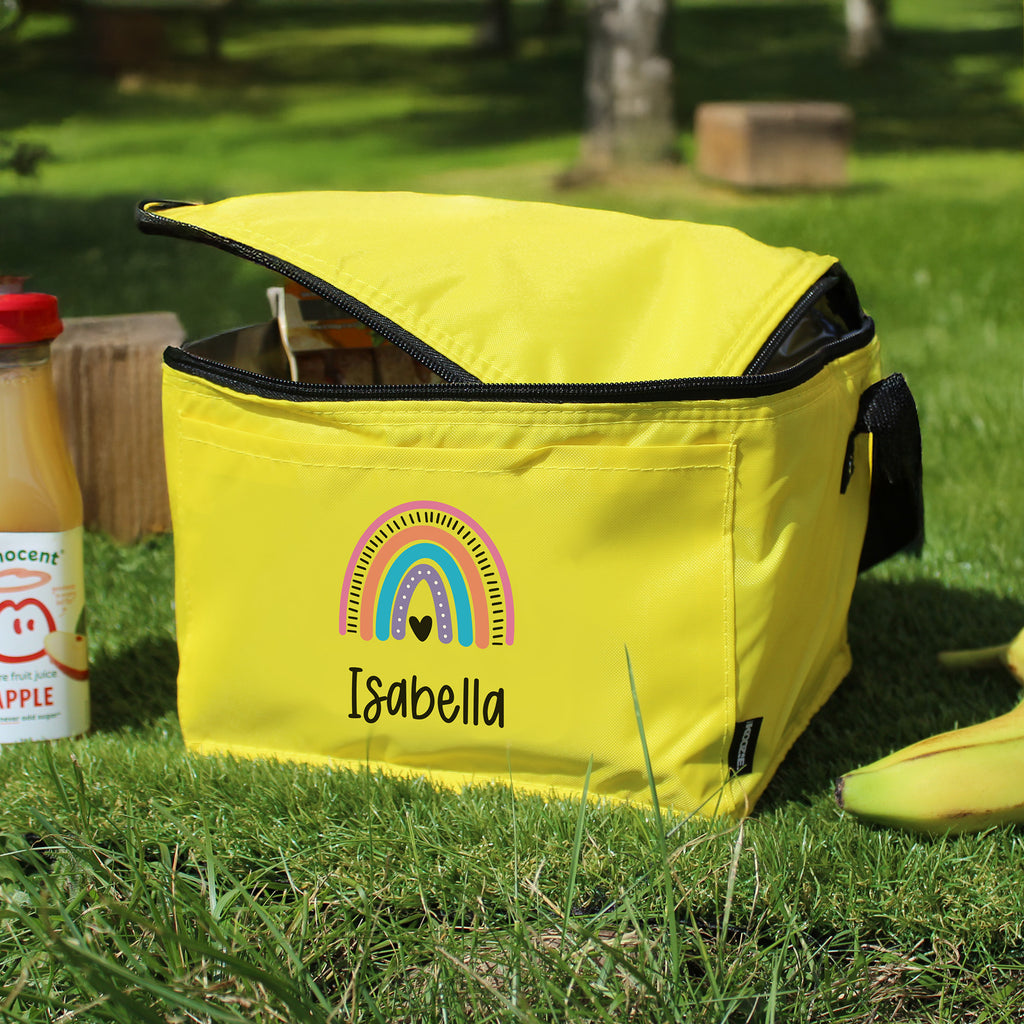 Yellow cooler bag with a rainbow design and 'Isabella' text on grass