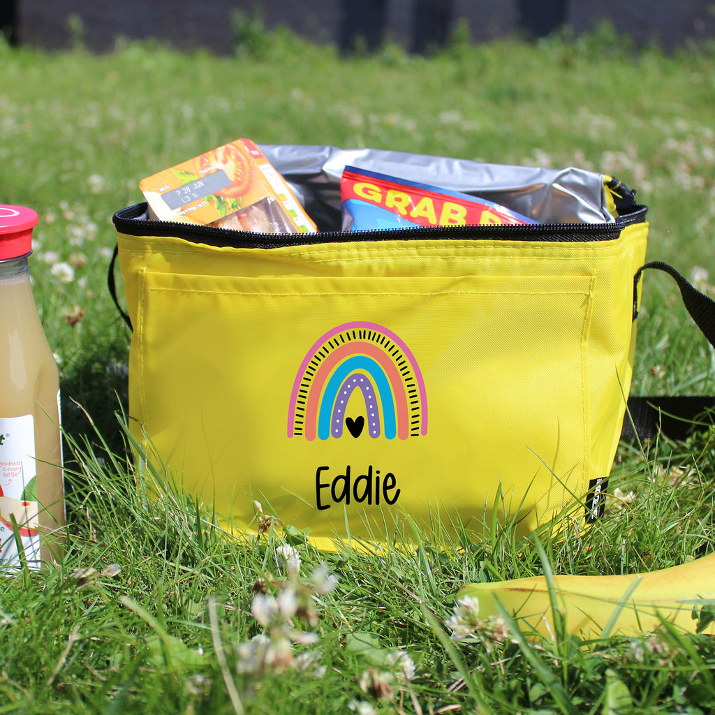 Yellow bag with a rainbow design and 'Eddie' text on grass