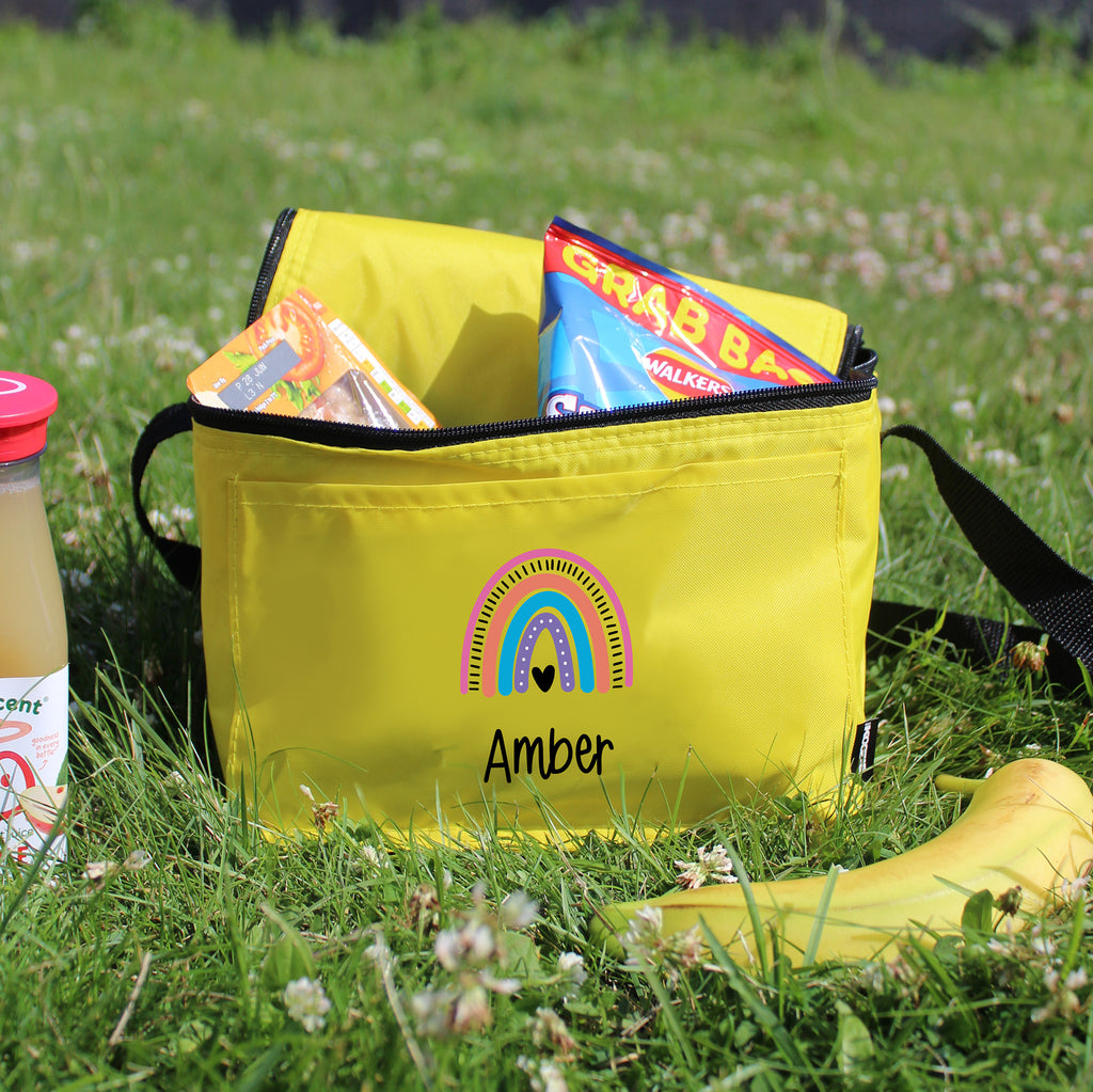 Yellow bag with a rainbow design and 'Amber' text on grass