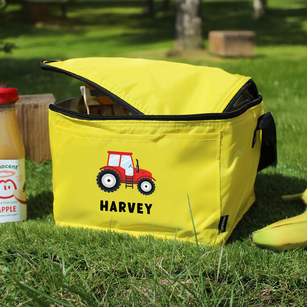 Yellow cooler bag with a red tractor design and 'Harvey' text on grass