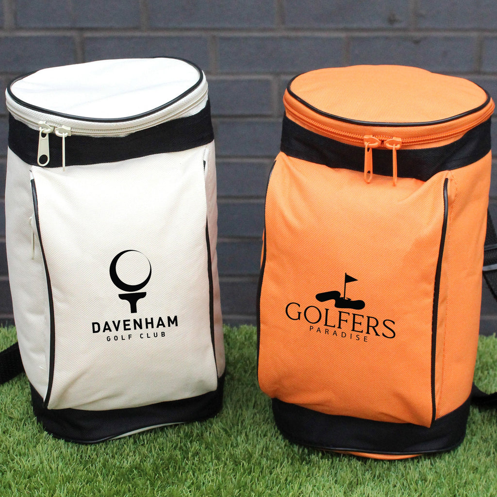 Two golf bags, one white and one orange, with visible brand logos on a grassy background.