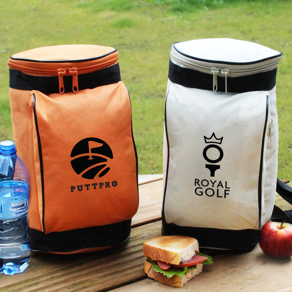 Orange and white cooler bags with 'PUTTPRO' and 'ROYAL GOLF' logos on a wooden surface with food and water.