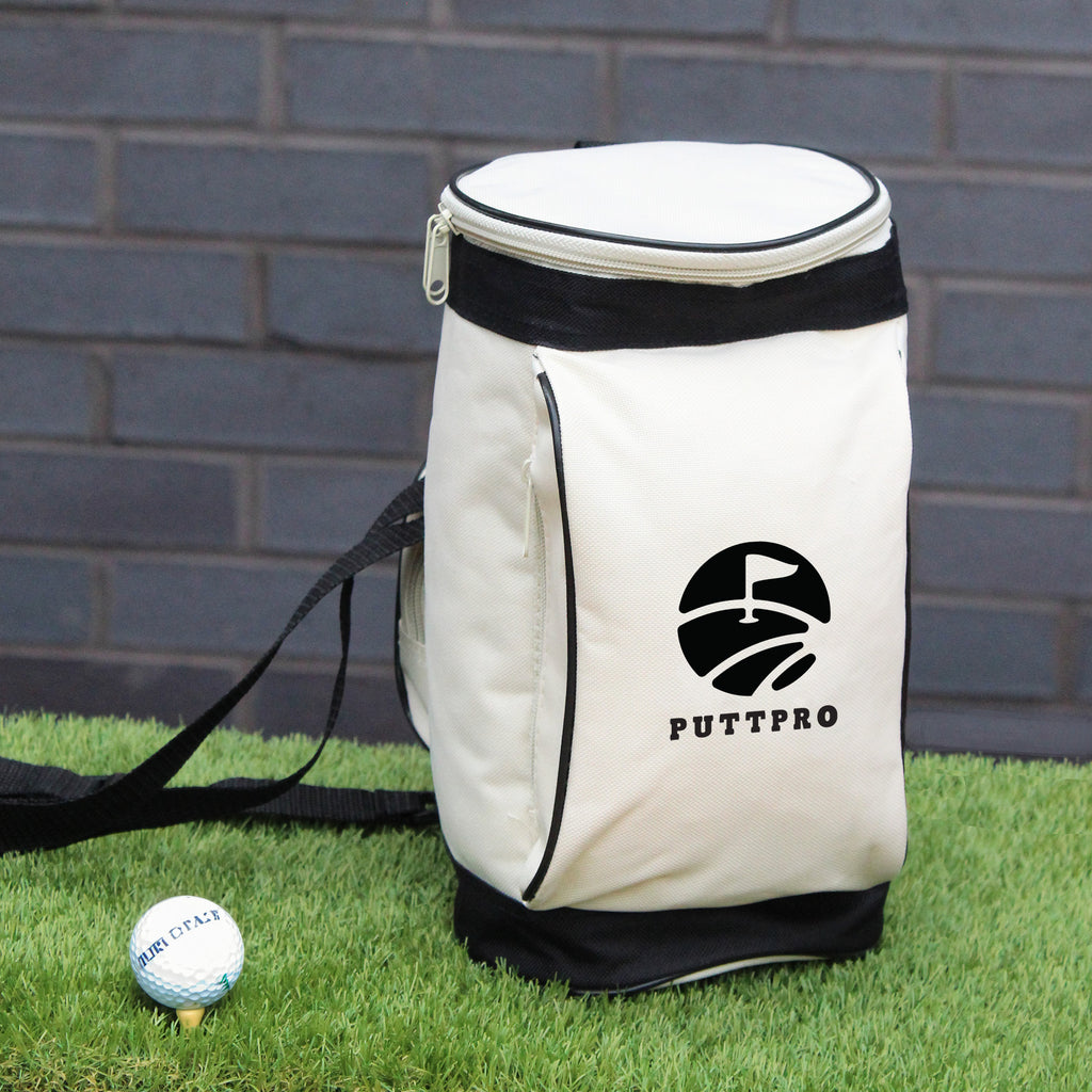 White golf bag with black trim and 'PUTTPRO' logo on grass against a brick wall.