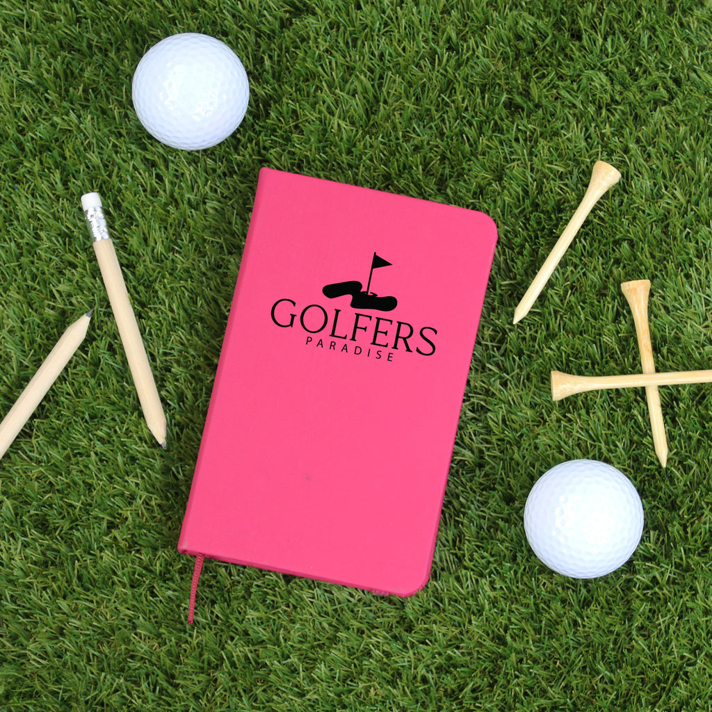 Pink notebook with 'Golfers Paradise' on a grass background with golf balls and tees.