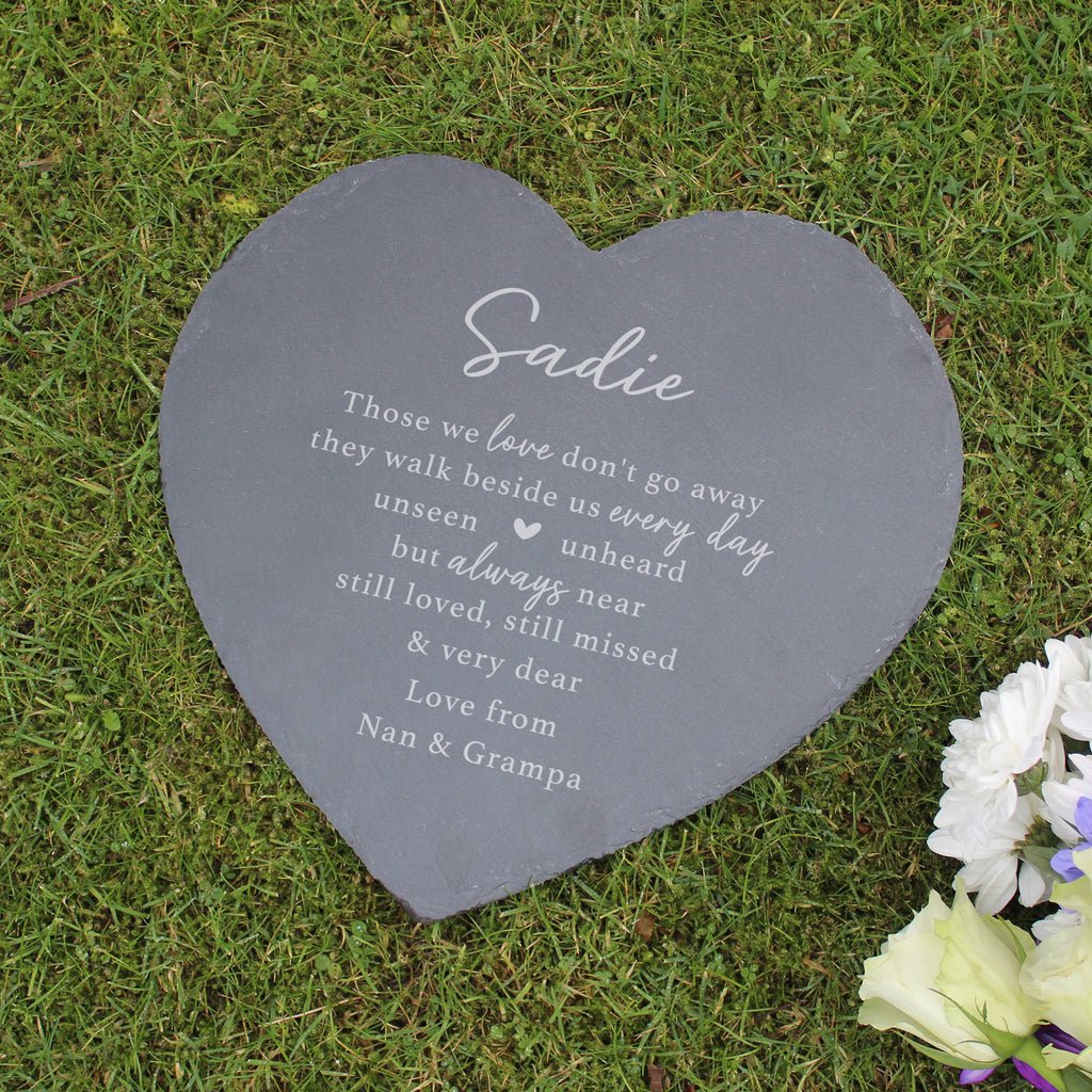 Heart-shaped slate plaque with engraved text on grass