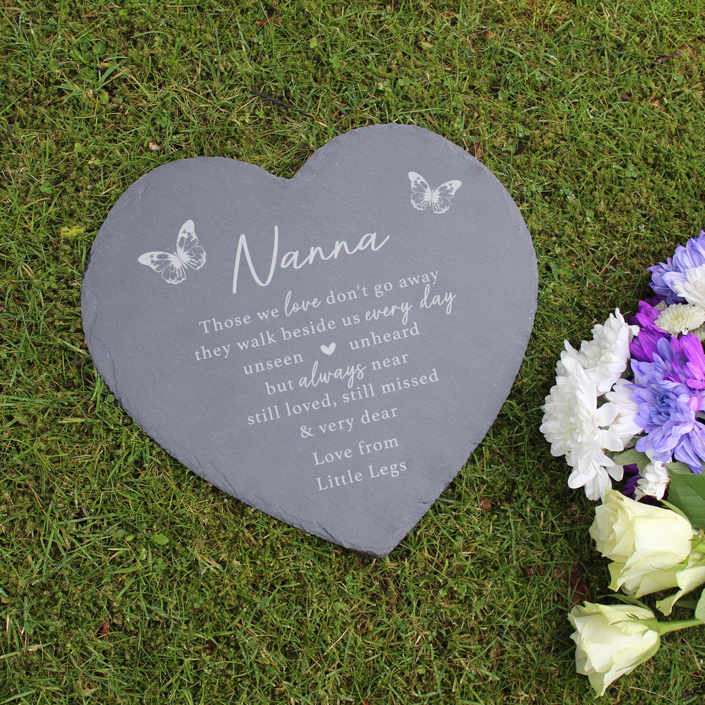 Heart-shaped slate plaque with engraved text on grass