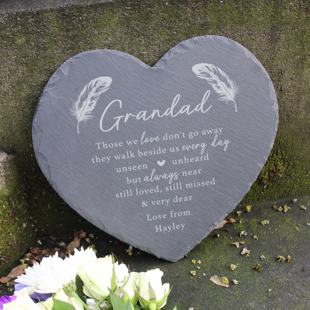 Heart-shaped slate plaque with engraved text against grave