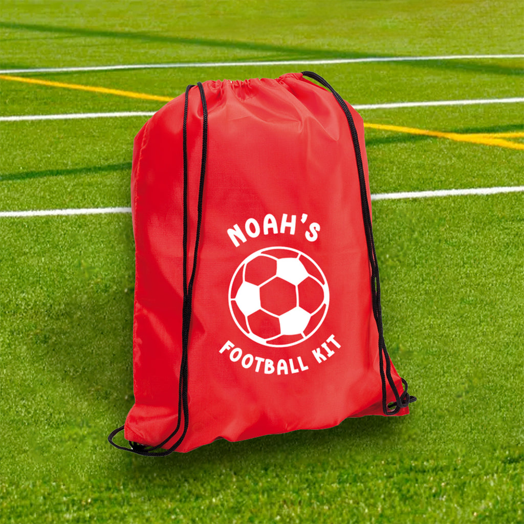 Red drawstring bag with 'NOAH'S FOOTBALL KIT' on a grass field