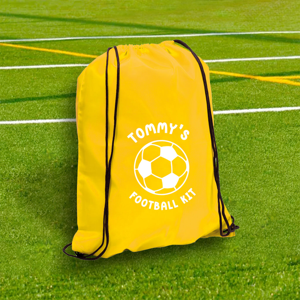 Yellow drawstring bag with 'Tommy's Football Kit' on a grass field