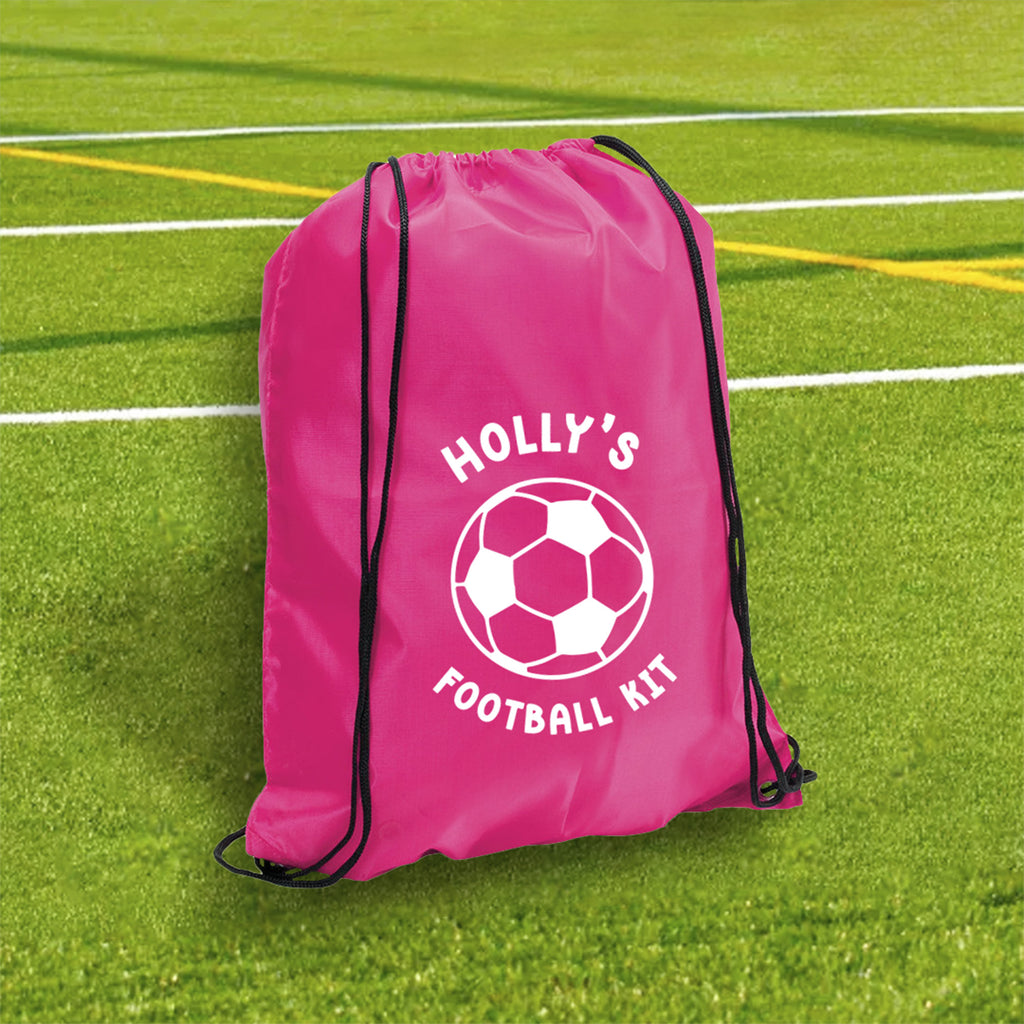 Pink drawstring bag with 'Holly's Football Kit' on a grass field