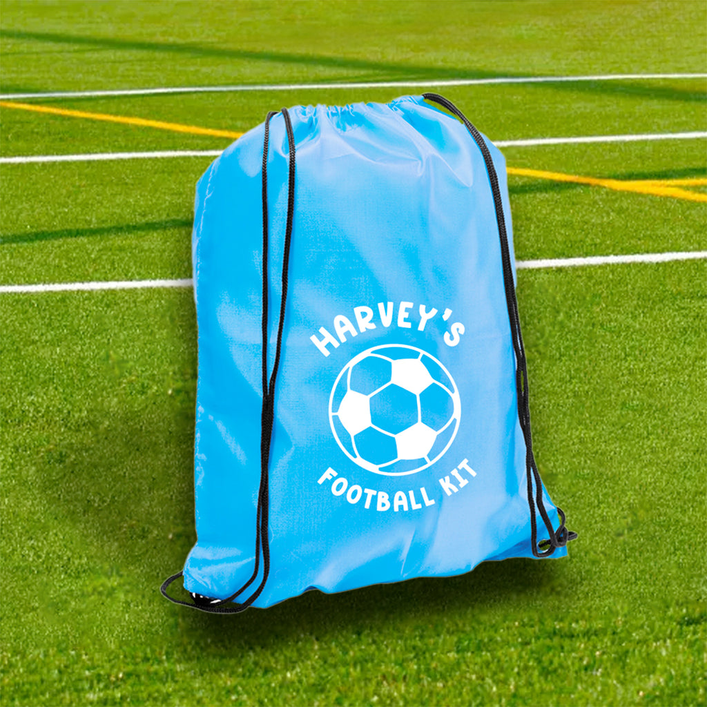 Blue drawstring bag labeled 'Harvey's Football Kit' on a grass field
