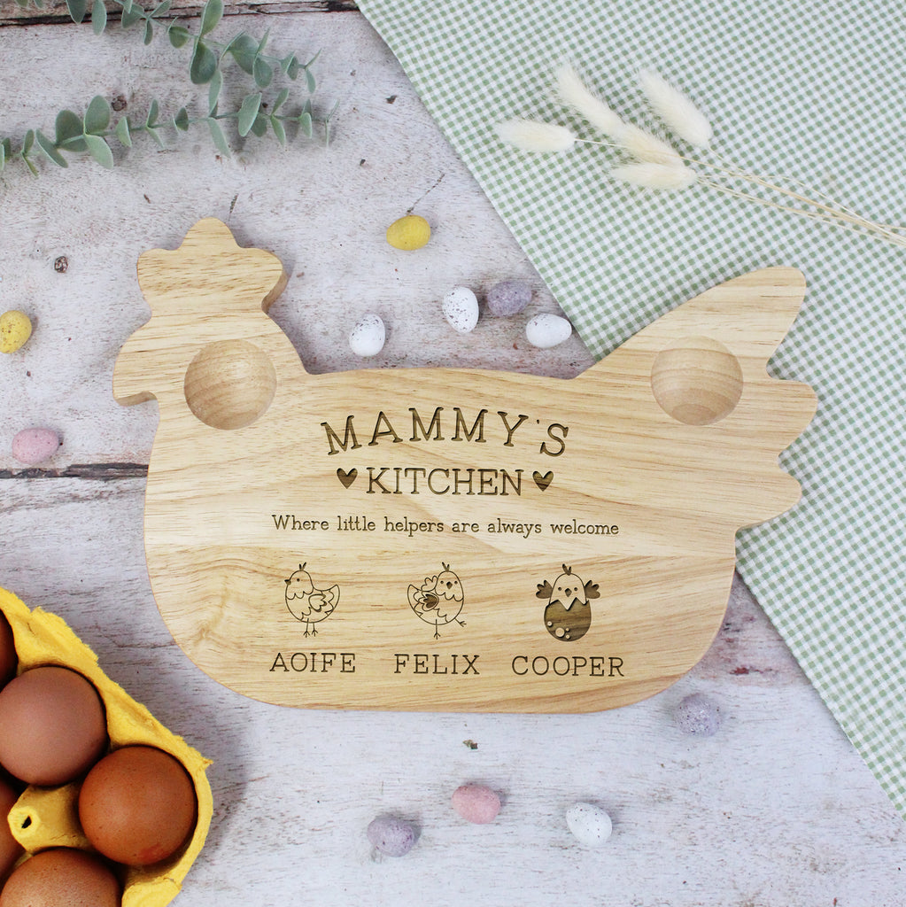 Wooden cutting board shaped like a chicken with engraved text on a rustic background.