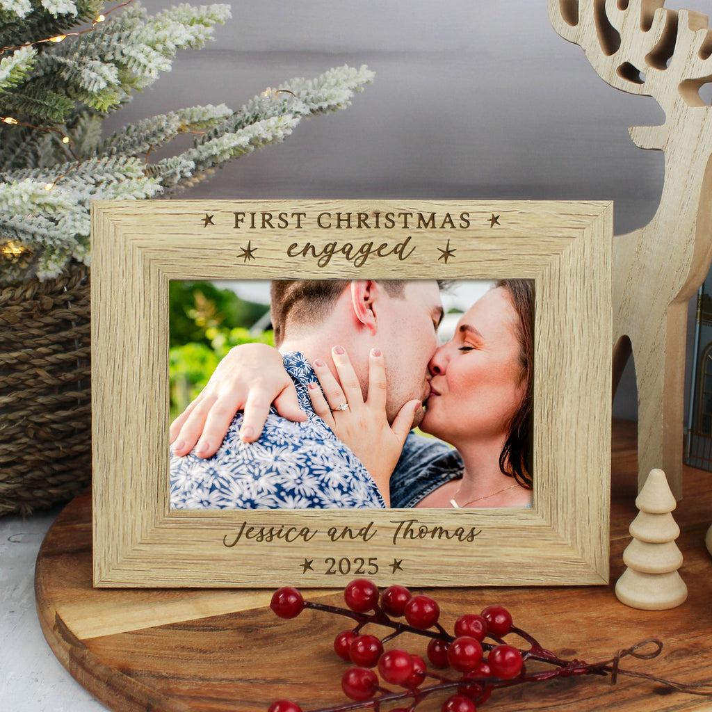 Personalized photo frame with a couple's photo and 'First Christmas engaged' text, surrounded by festive decorations.