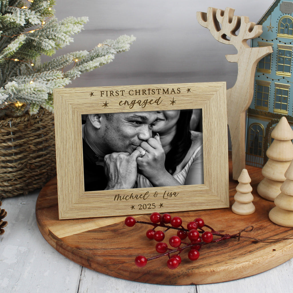 Wooden photo frame with a Christmas theme, displaying a couple and the text 'First Christmas engaged Michael & Lisa 2025'.
