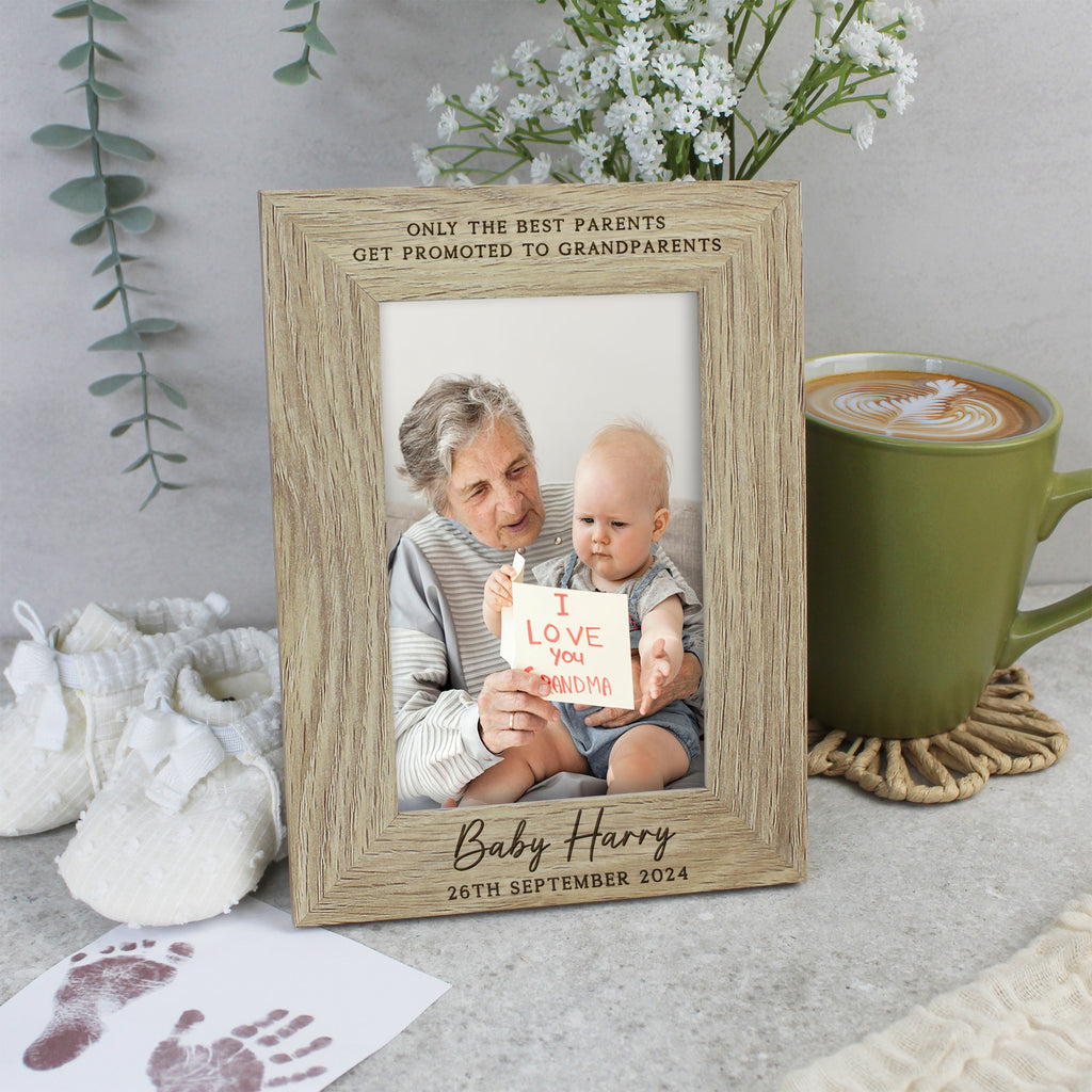 Wooden photo frame with a picture of a woman and a baby, text 'Only the best parents get promoted to grandparents' and 'Baby Harry 26th September 2024'.
