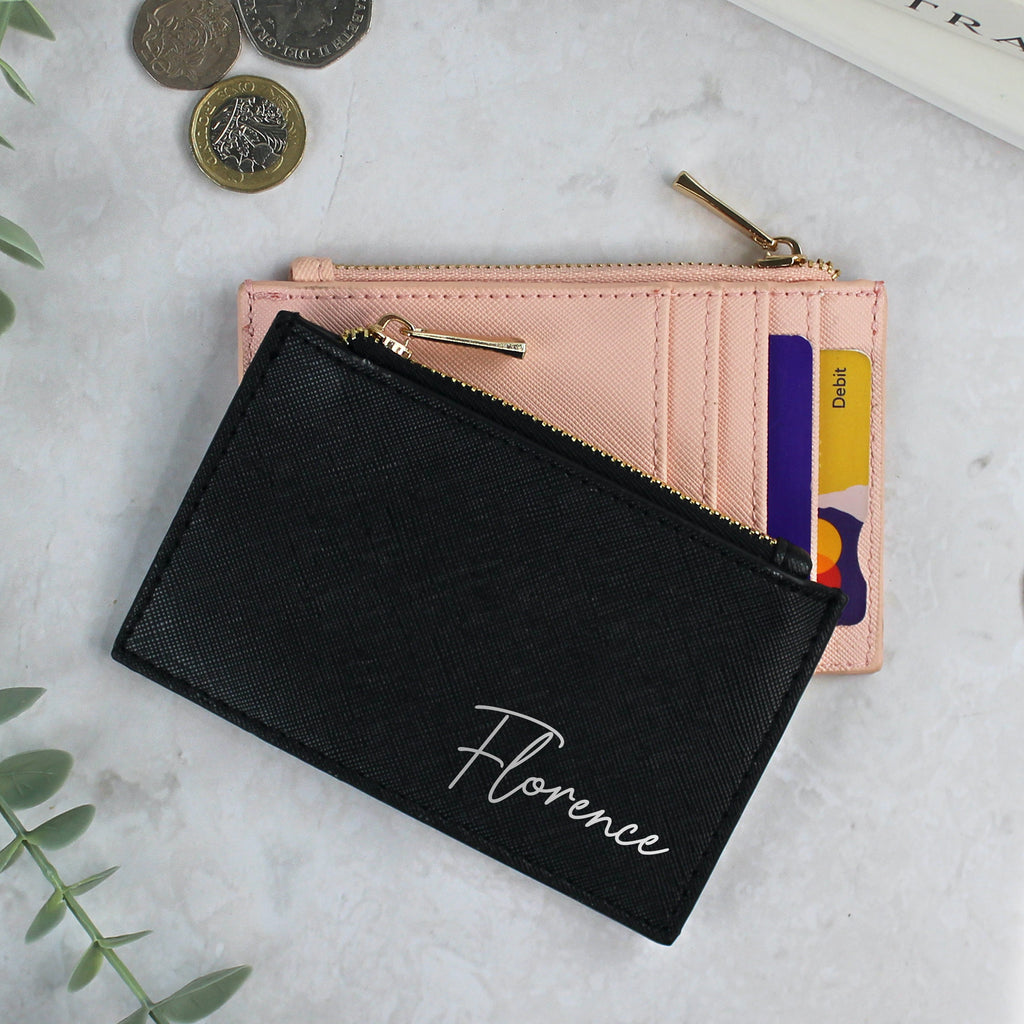 Black wallet with 'Florence' branding on a light surface with coins and cards.