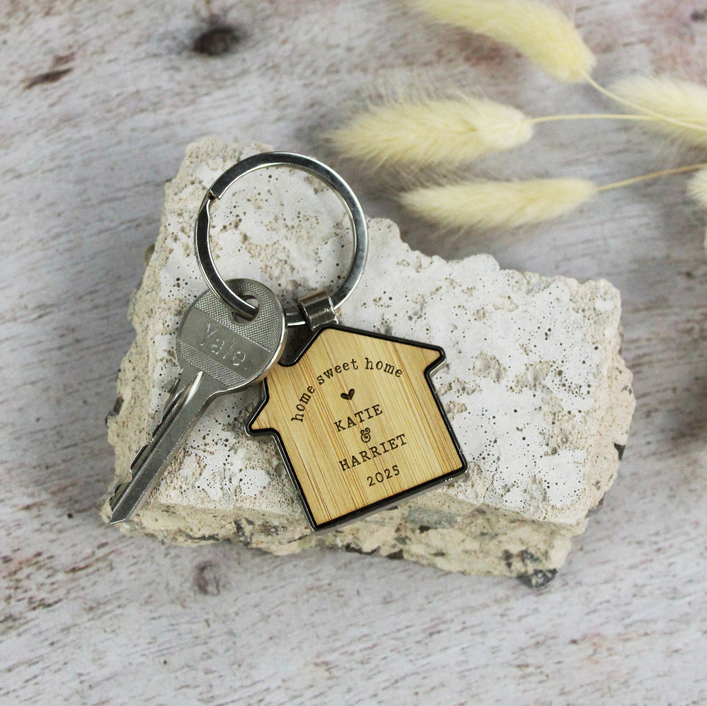 Keychain with wooden tag on a rock with dried grass in the background