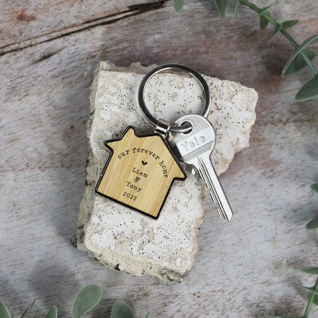 Keychain with wooden house-shaped tag on a rock