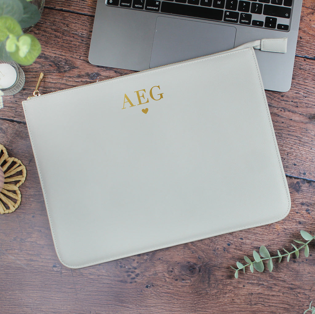 Light gray pouch with 'AEG' initials on a wooden surface with a laptop.