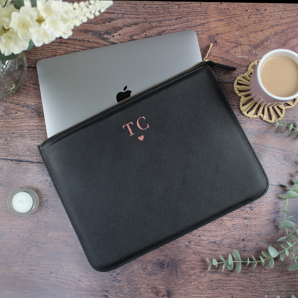 Black laptop sleeve with initials on a wooden surface with a laptop and coffee cup.