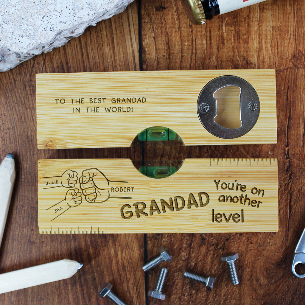 Wooden tool with engraved text and bottle opener on a wooden surface