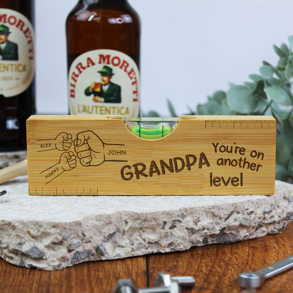 Wooden level with engraved message on a stone surface with bottles in the background