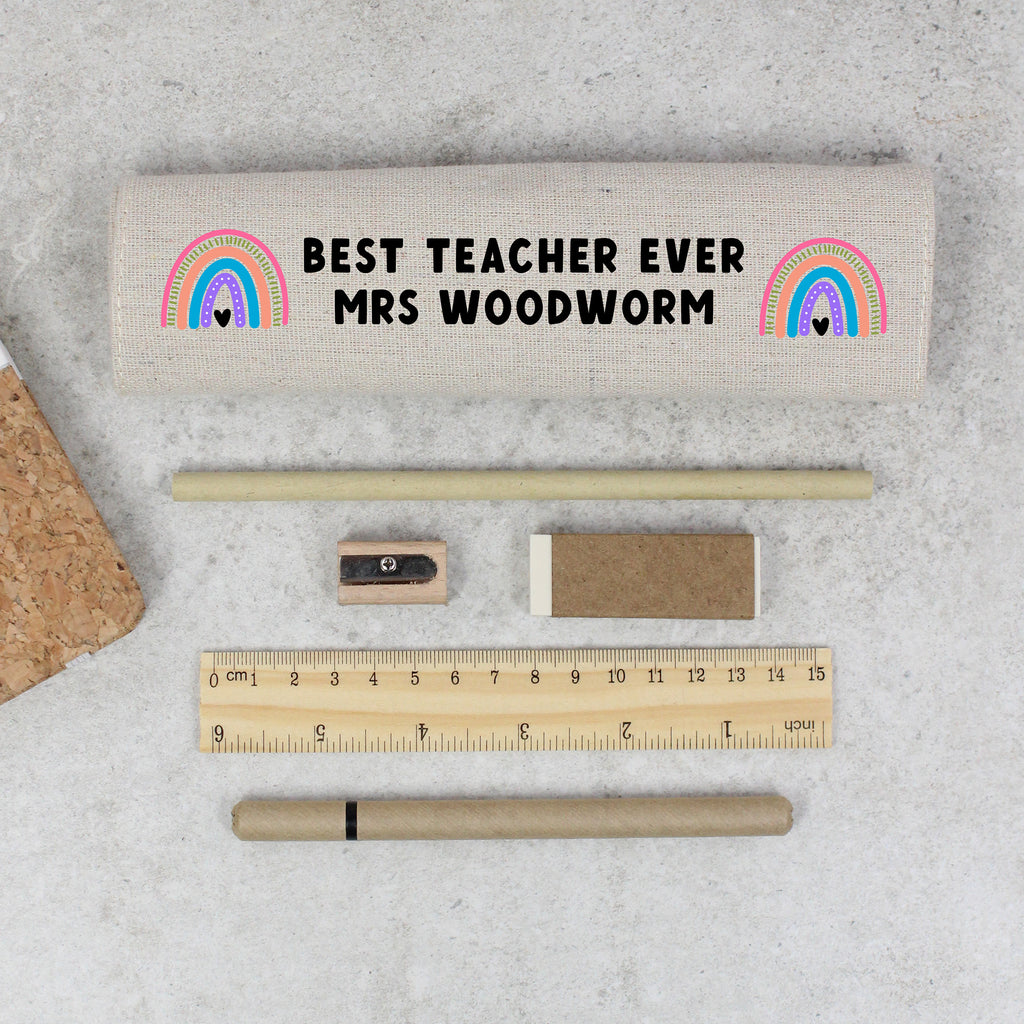 Teacher appreciation gift set with pencil case, ruler, pen, eraser, and sharpener on a concrete surface.