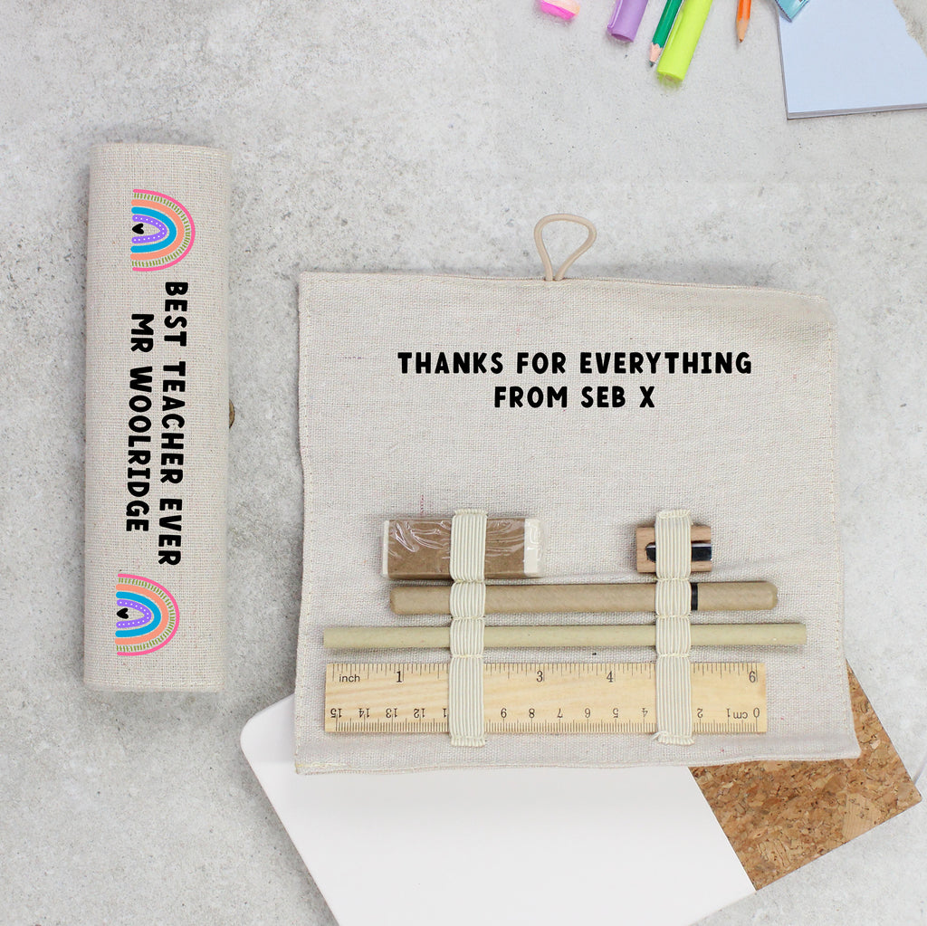 Personalized gift set with stationery items and a card on a textured surface.