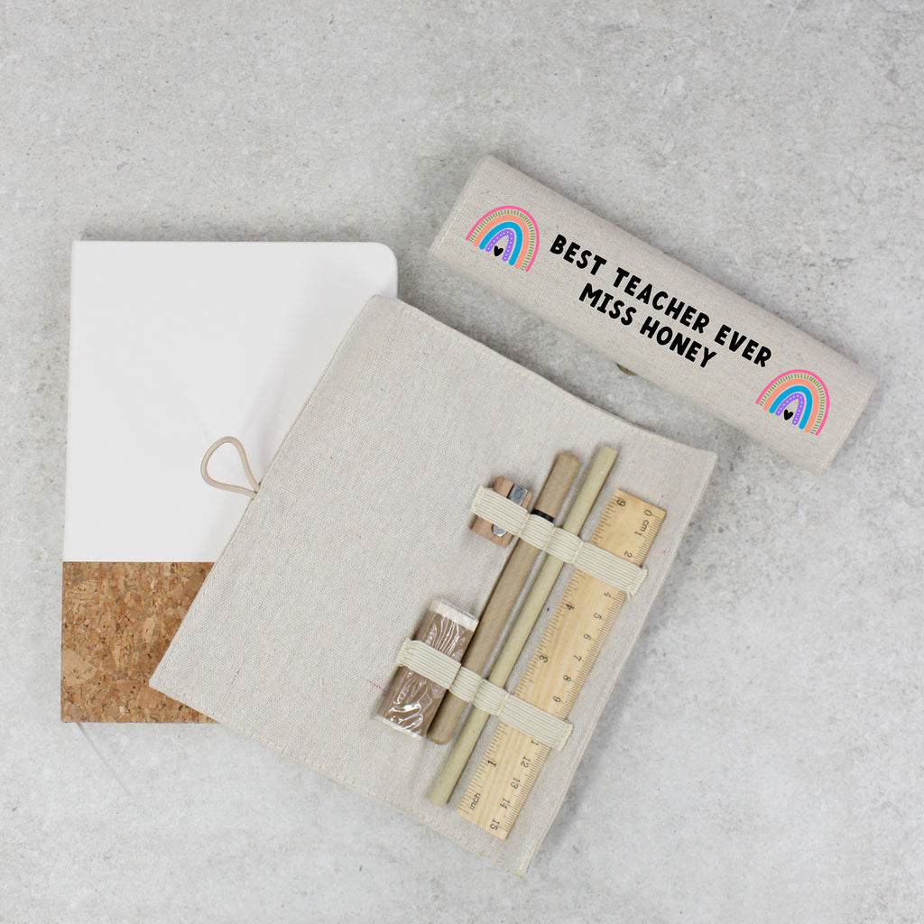 Teacher appreciation gift set with notebook, pens, and ruler on a gray surface