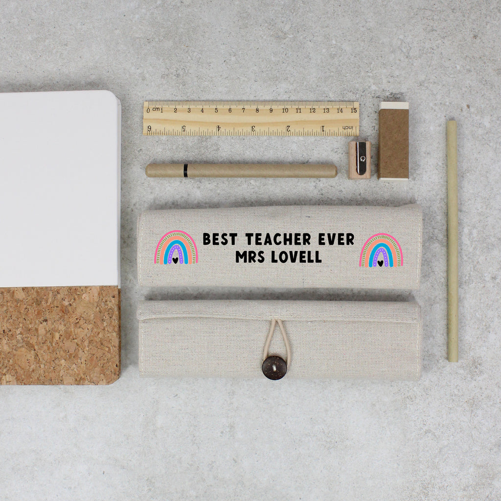 Stationery items including a ruler, pen, and eraser on a concrete surface with a personalized pouch.