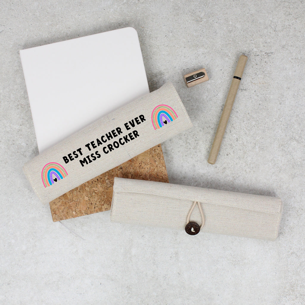 Personalized pencil case with rainbow design and text on a gray surface