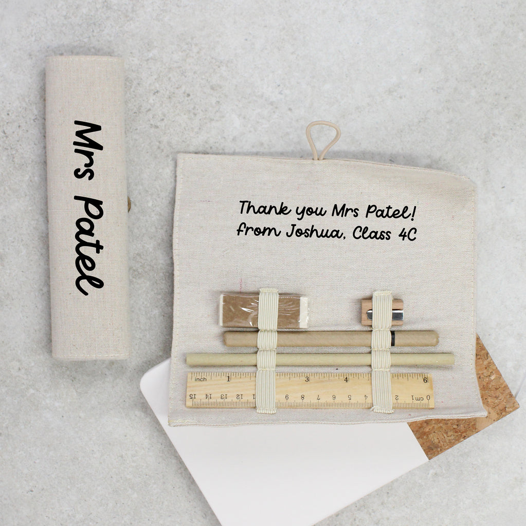 Personalized teacher gift set with stationery items on a textured surface