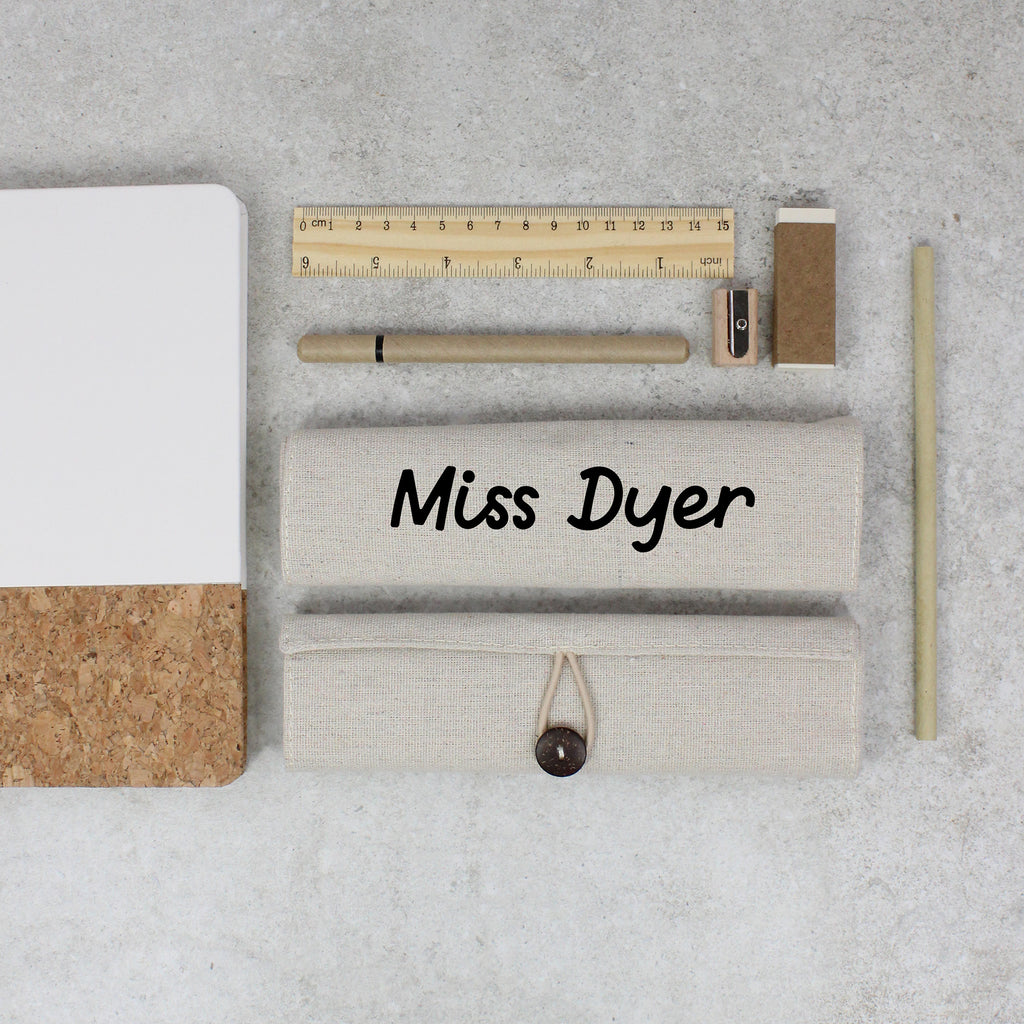 Stationery items including a ruler, pen, and cork board on a gray surface with 'Miss Dyer' branding.