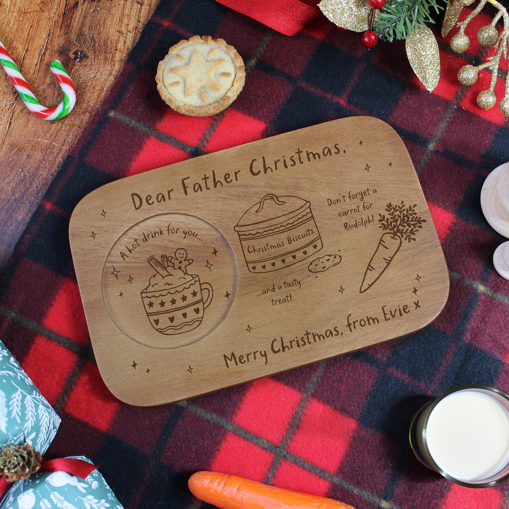 Wooden Christmas platter with engraved design on a festive tablecloth.