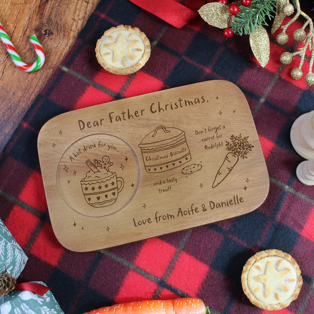 Wooden tray with engraved Christmas-themed message on a plaid fabric background