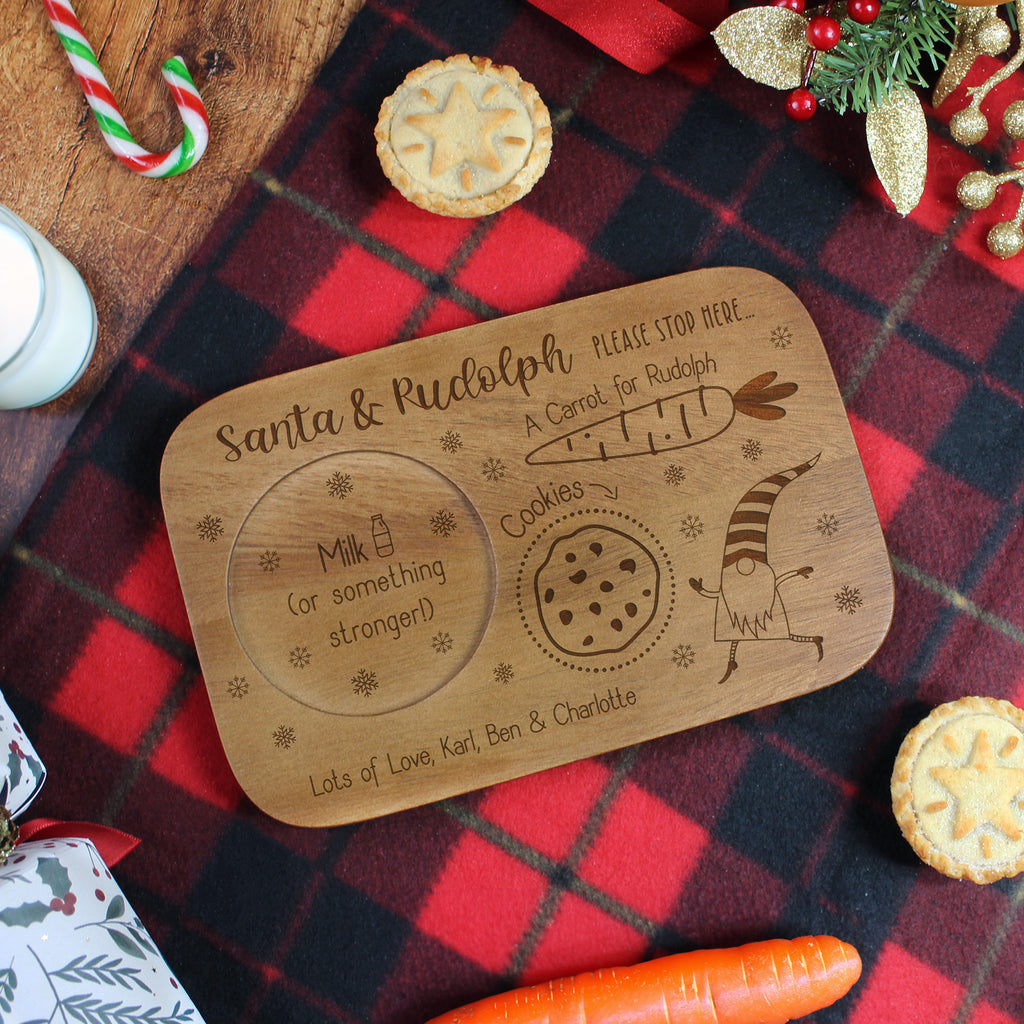 Wooden tray with Christmas-themed design on a red plaid fabric background