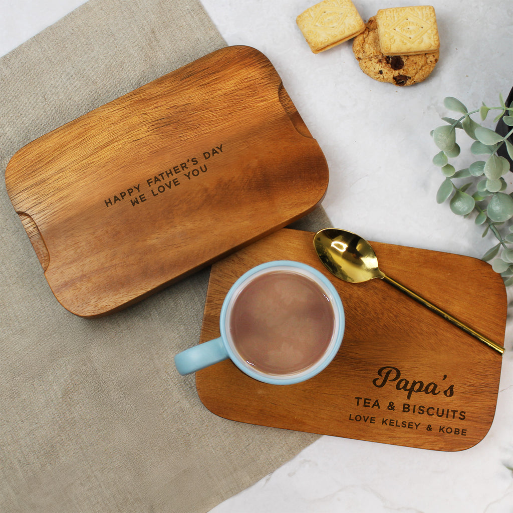 Wooden tray with 'Happy Father's Day' message, mug, spoon, and cookies on a neutral background