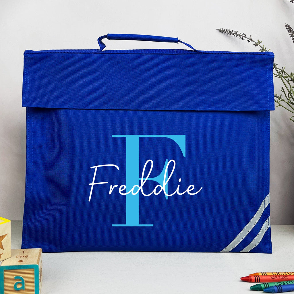 Blue box with 'Freddie' and a large 'F' on it, surrounded by children's items like blocks and crayons.