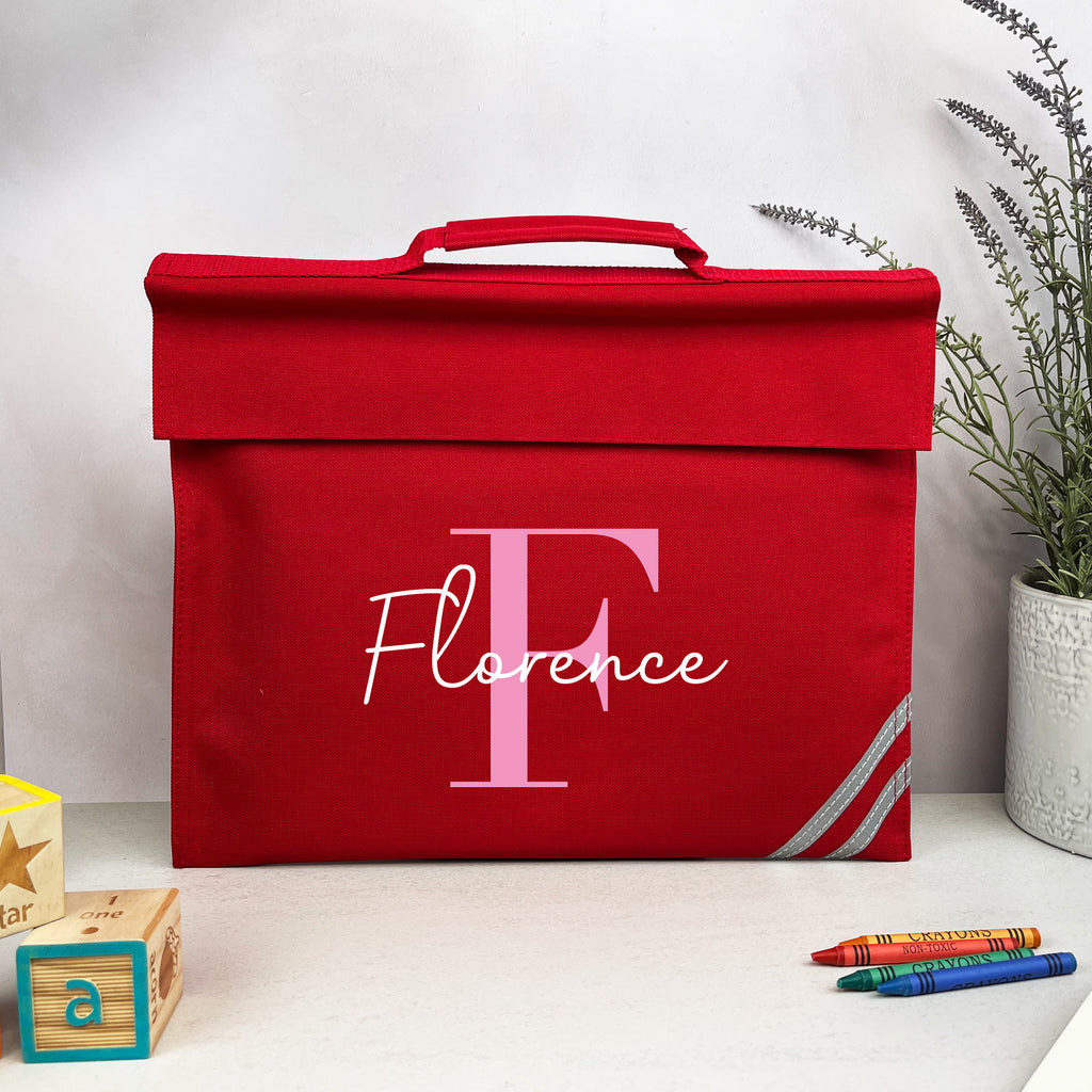 Red storage box with 'Florence' branding on a white surface with decorative items.