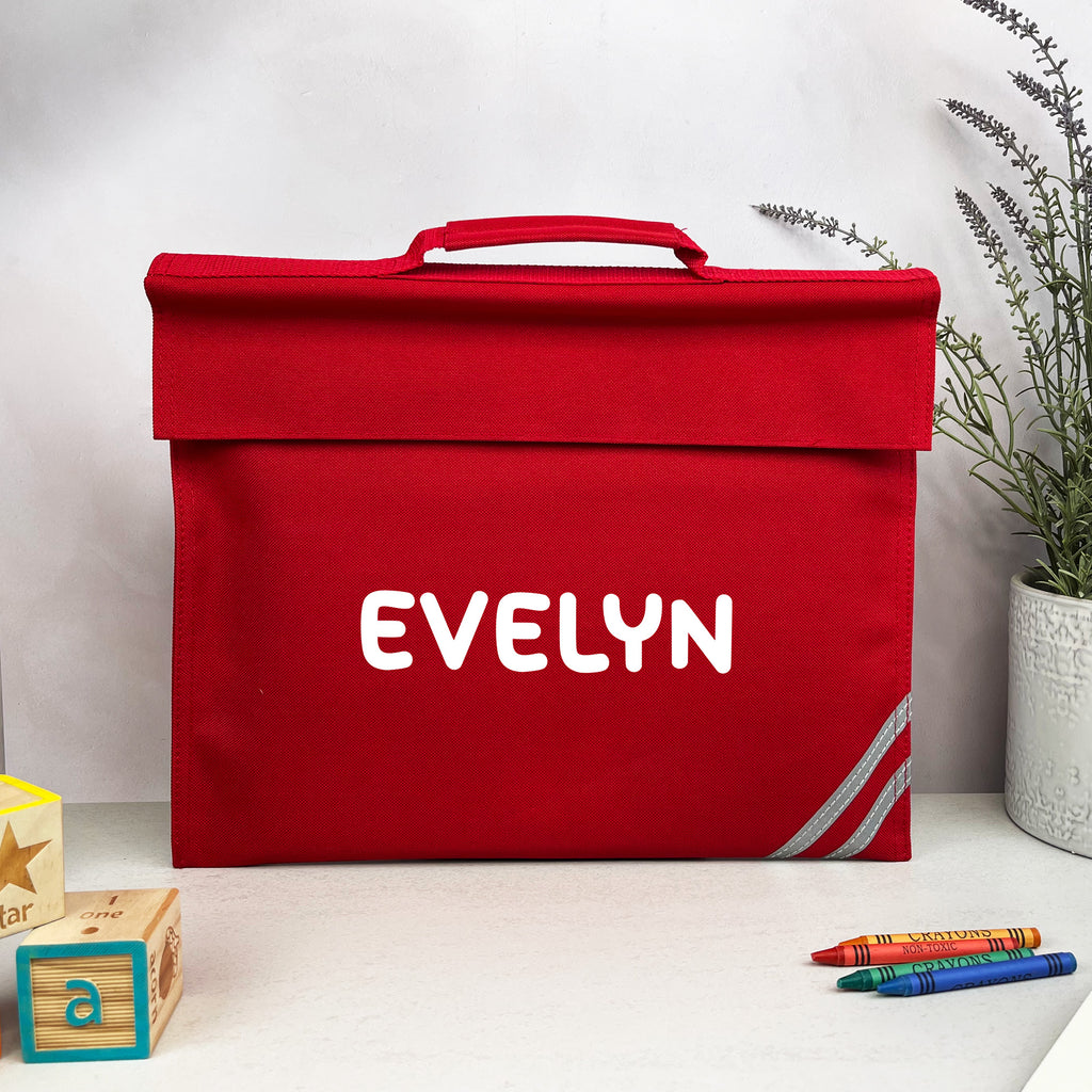 Red storage box with 'EVELYN' printed on it, placed on a white surface with a plant in the background.