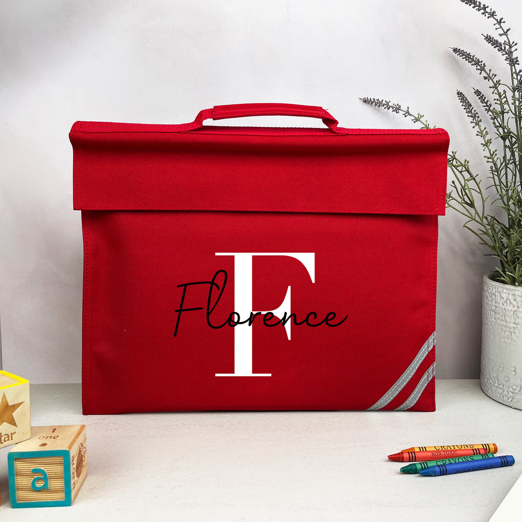 Red storage box with 'Florence' and a large 'F' on a white surface with decorative items.