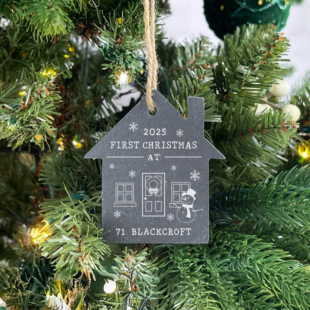 Decorative ornament on a Christmas tree with '2022 First Christmas at' text.