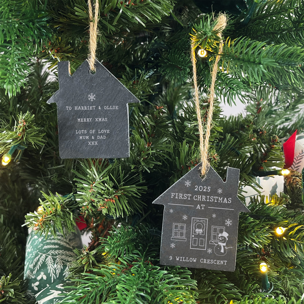 House-shaped Christmas ornaments on a decorated tree