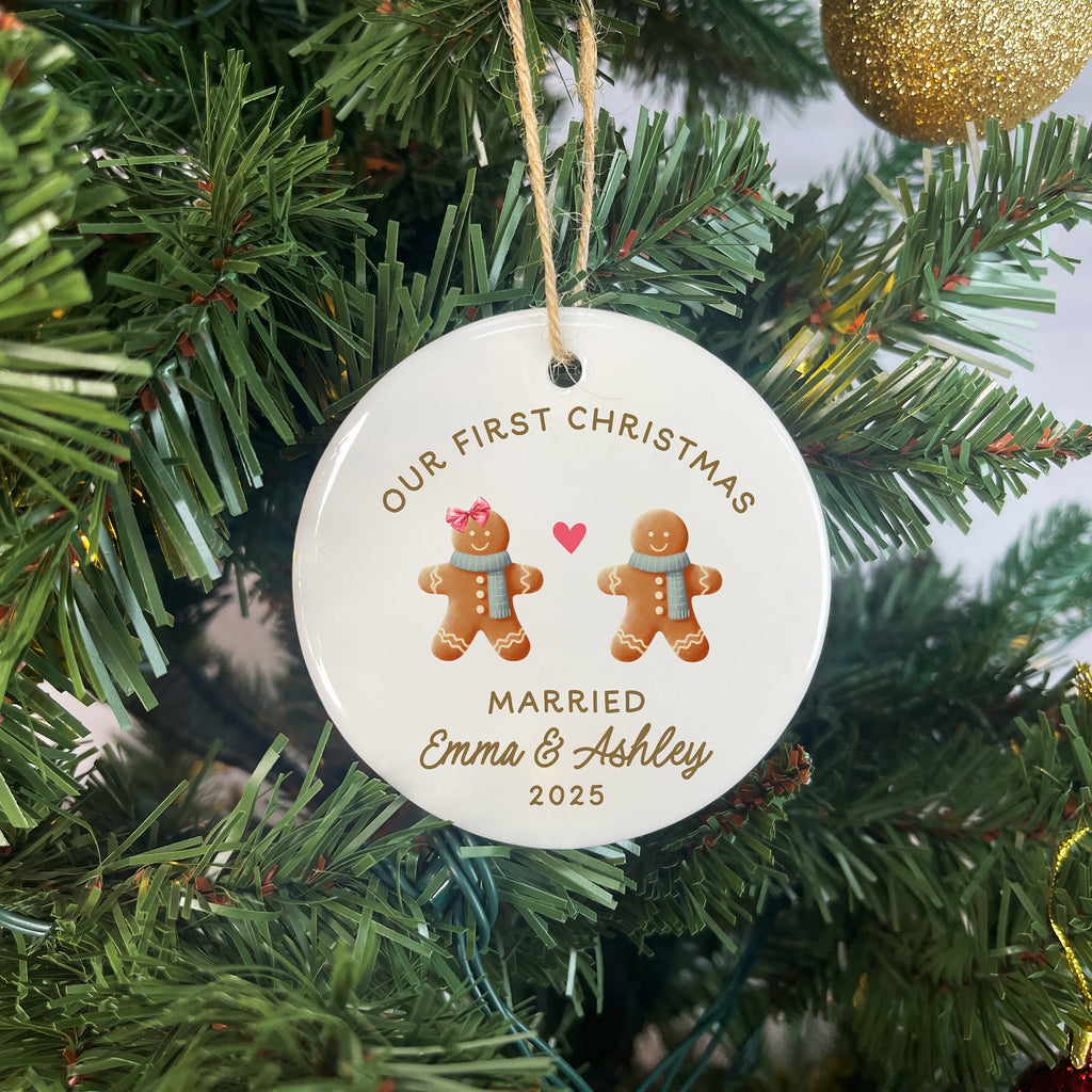 Decorative Christmas ornament with gingerbread men and text on a tree.
