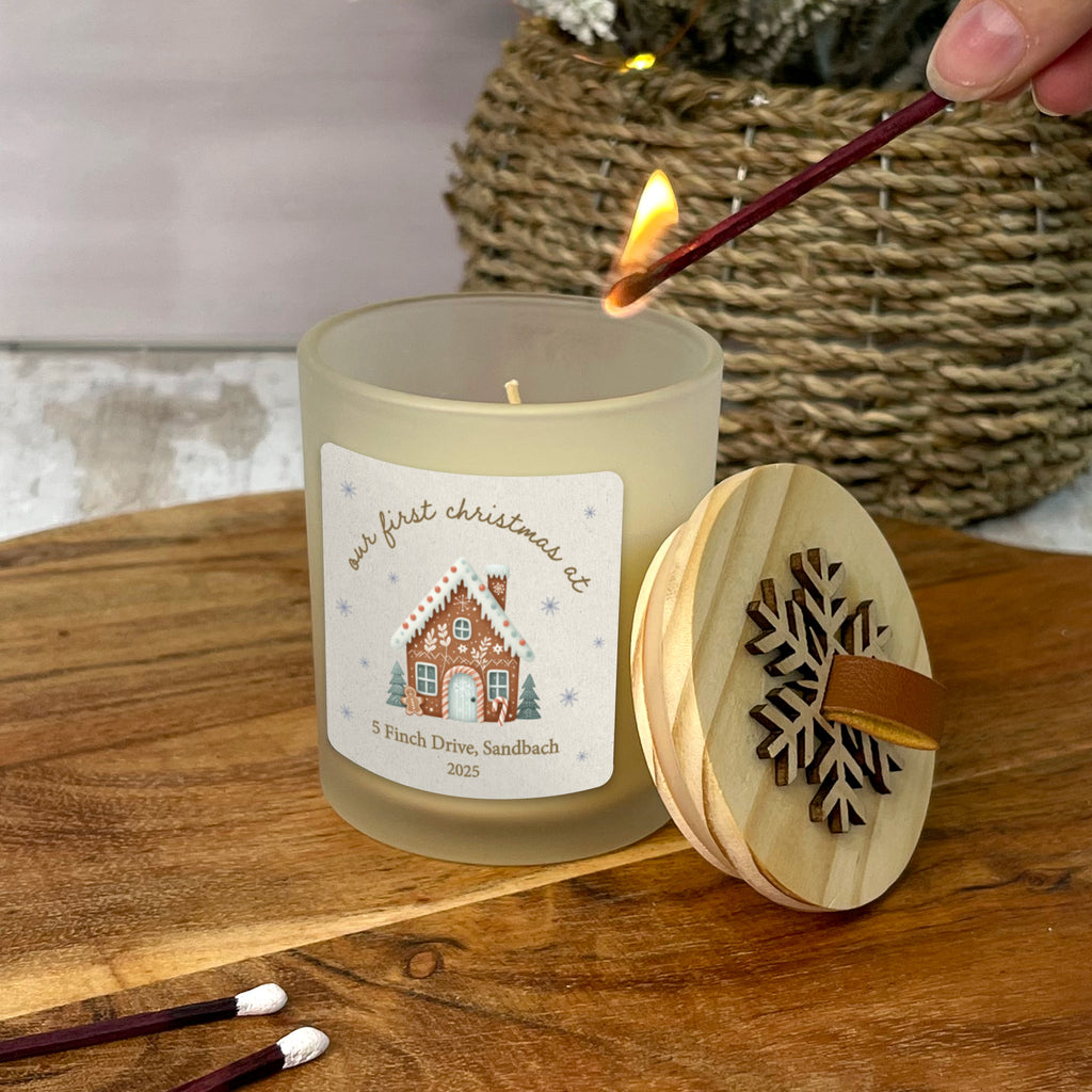 Candle being lit with a decorative label on a wooden surface