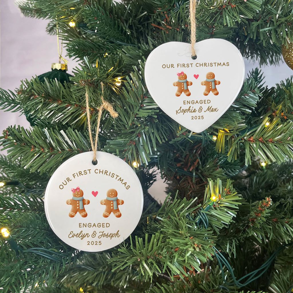 Two heart-shaped Christmas ornaments on a tree, featuring gingerbread men and text.