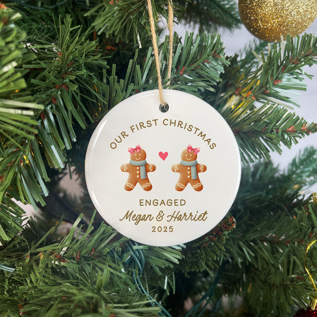 Personalized Christmas ornament with gingerbread men and text on a tree.