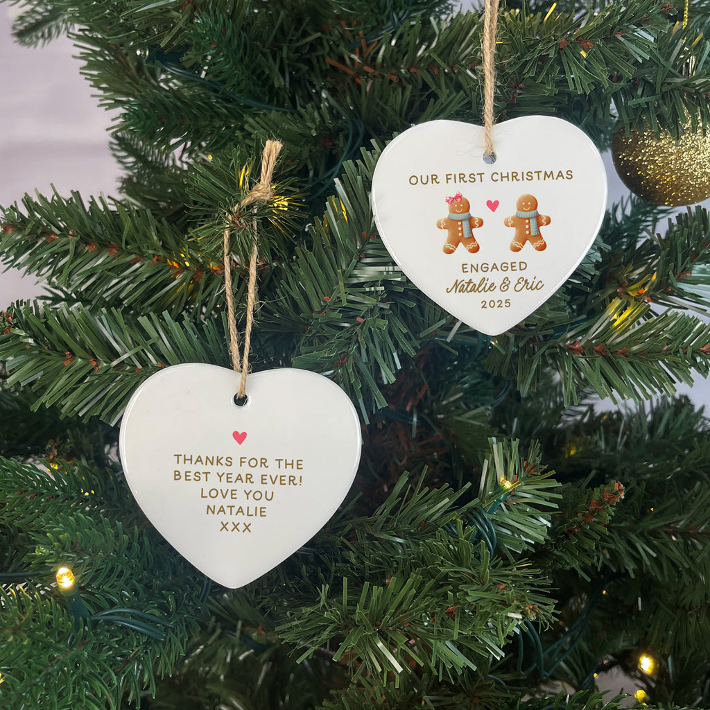 Heart-shaped Christmas ornaments on a tree with personalized messages.
