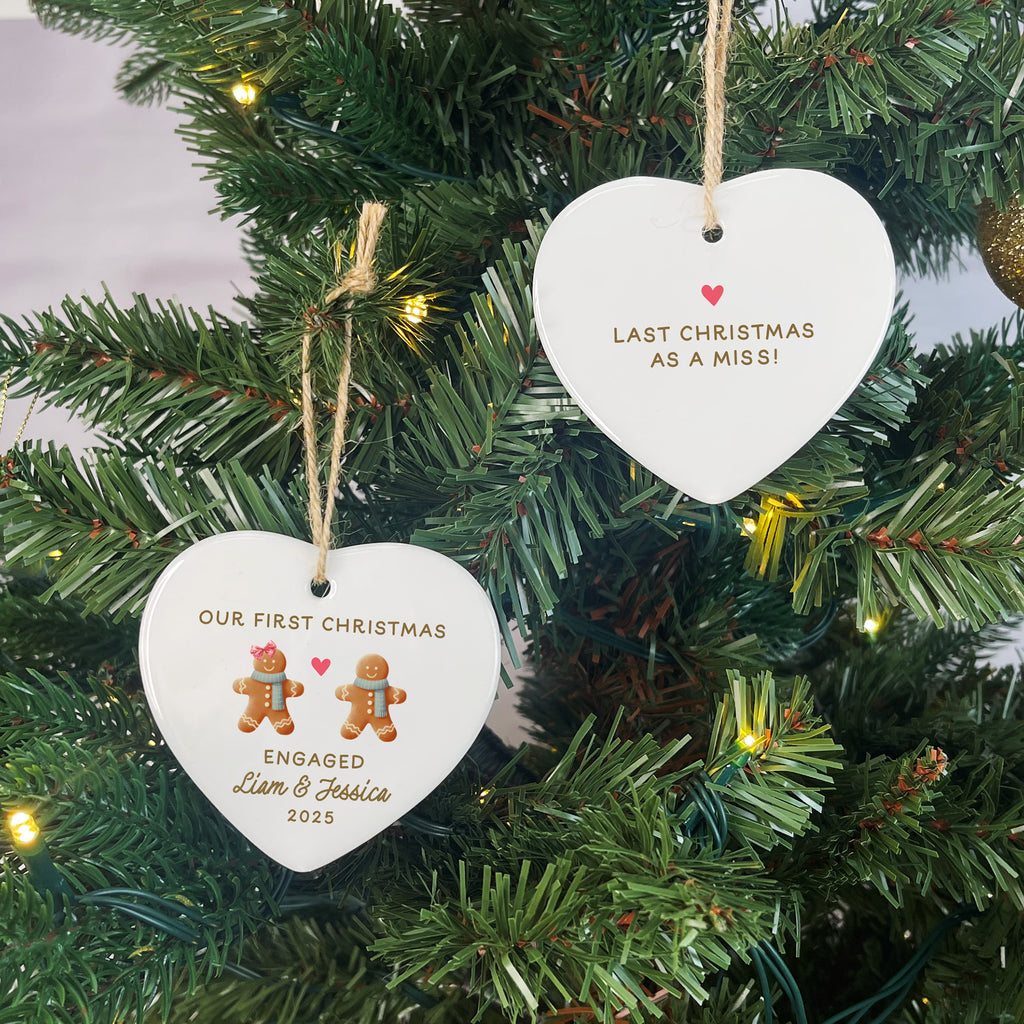 Two heart-shaped Christmas ornaments on a decorated tree.